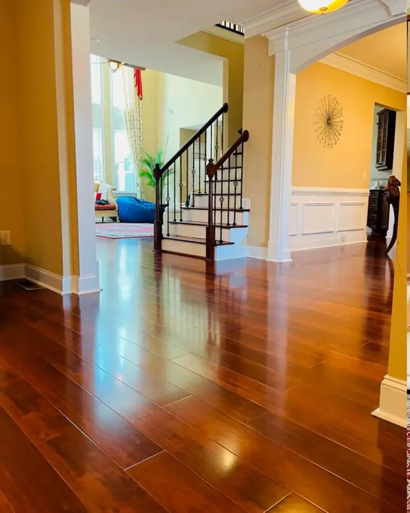 Glossy hardwood floor in a foyer leading to the stairs
