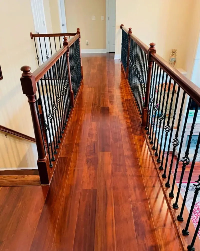 Deep, warm-toned hardwood floor along an upstairs hall